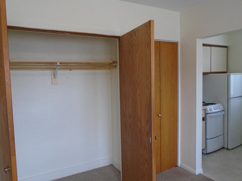 a bedroom with a closet and a laundry room with a washer and dryer